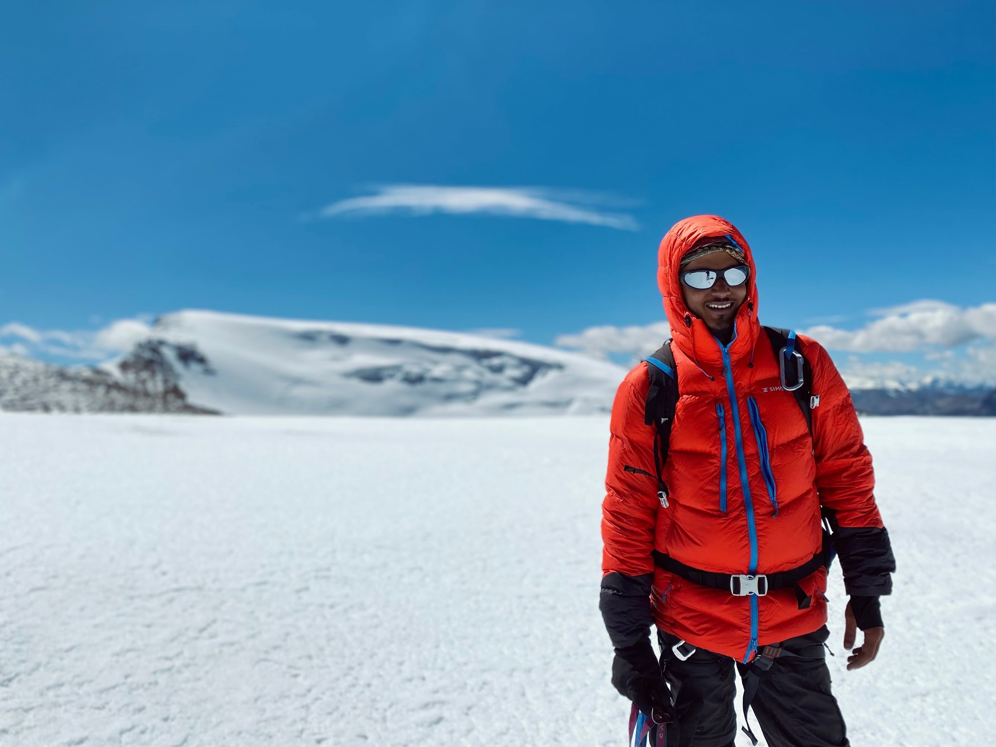 Climber on the Mentok Kangri glacier, snow peak behind