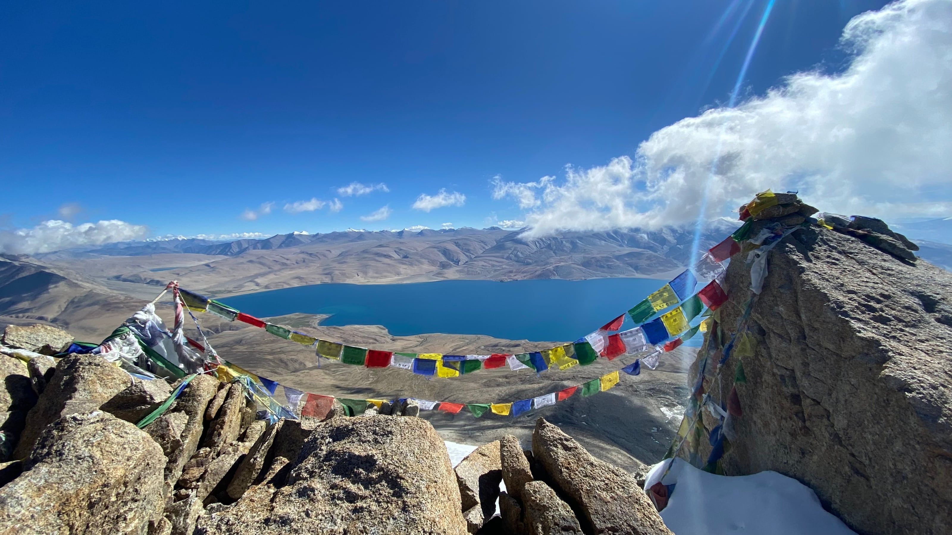 Prayer flags on the Mentok Kangri II summit, Tso Moriri below